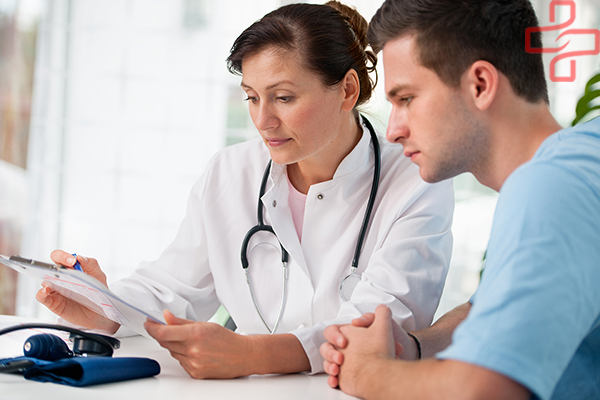 doctor talking to her male patient at office